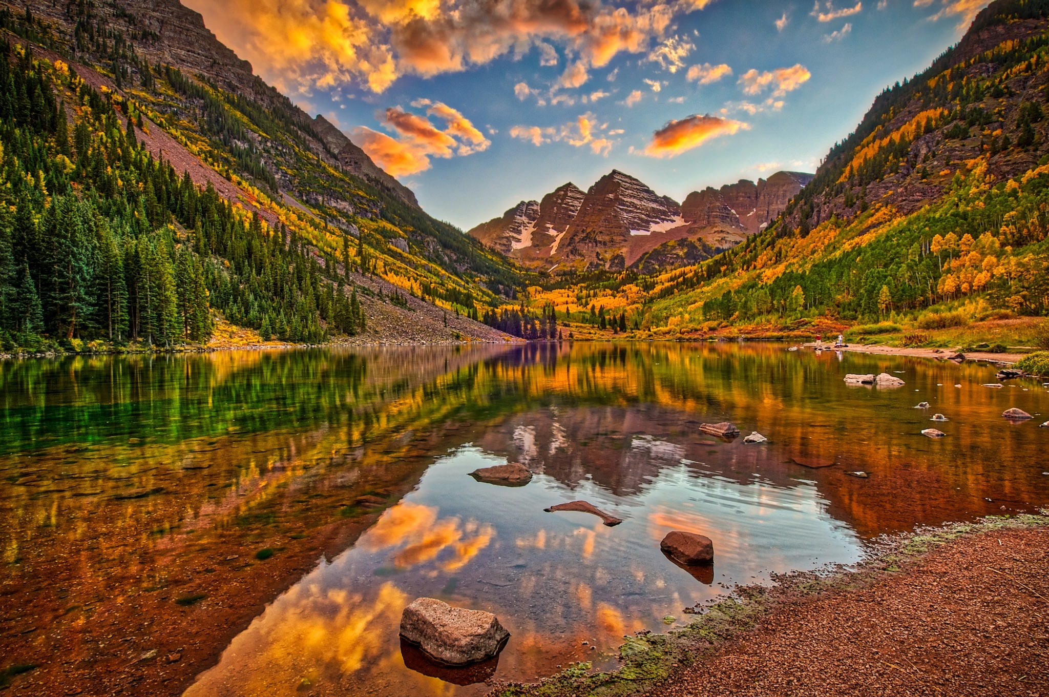 A colorful sunrise is reflected in the still waters of Maroon Lake in the Maroon Bells Recreation Arez near Aspen, Colorado.