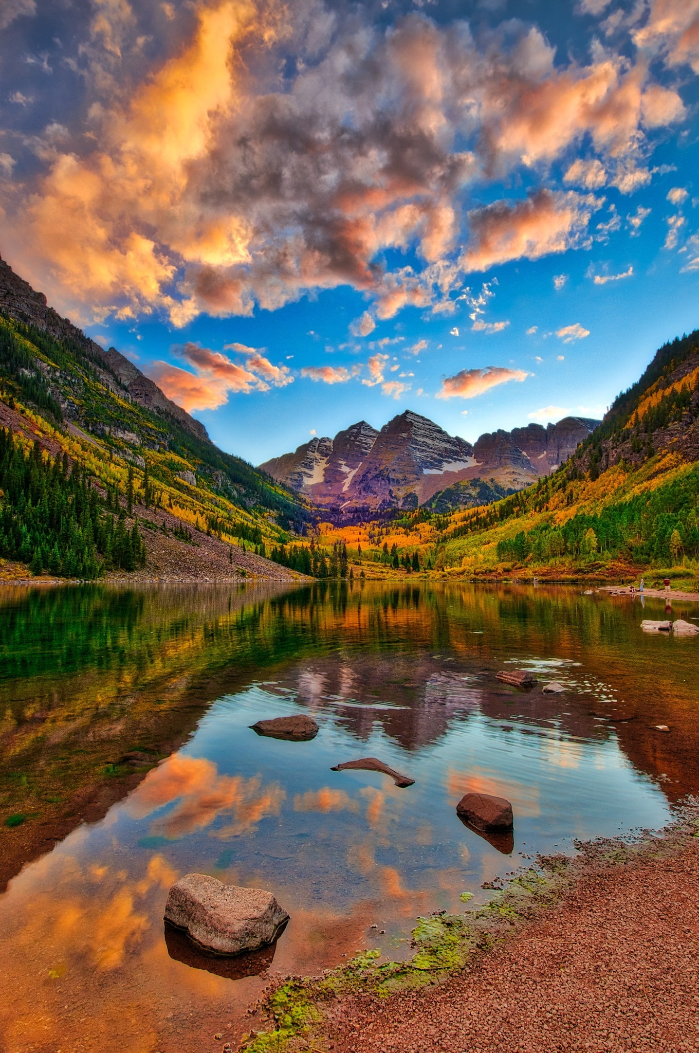 A colorful sunrise is reflected in the still waters of Maroon Lake in the Maroon Bells Recreation Arez near Aspen, Colorado.