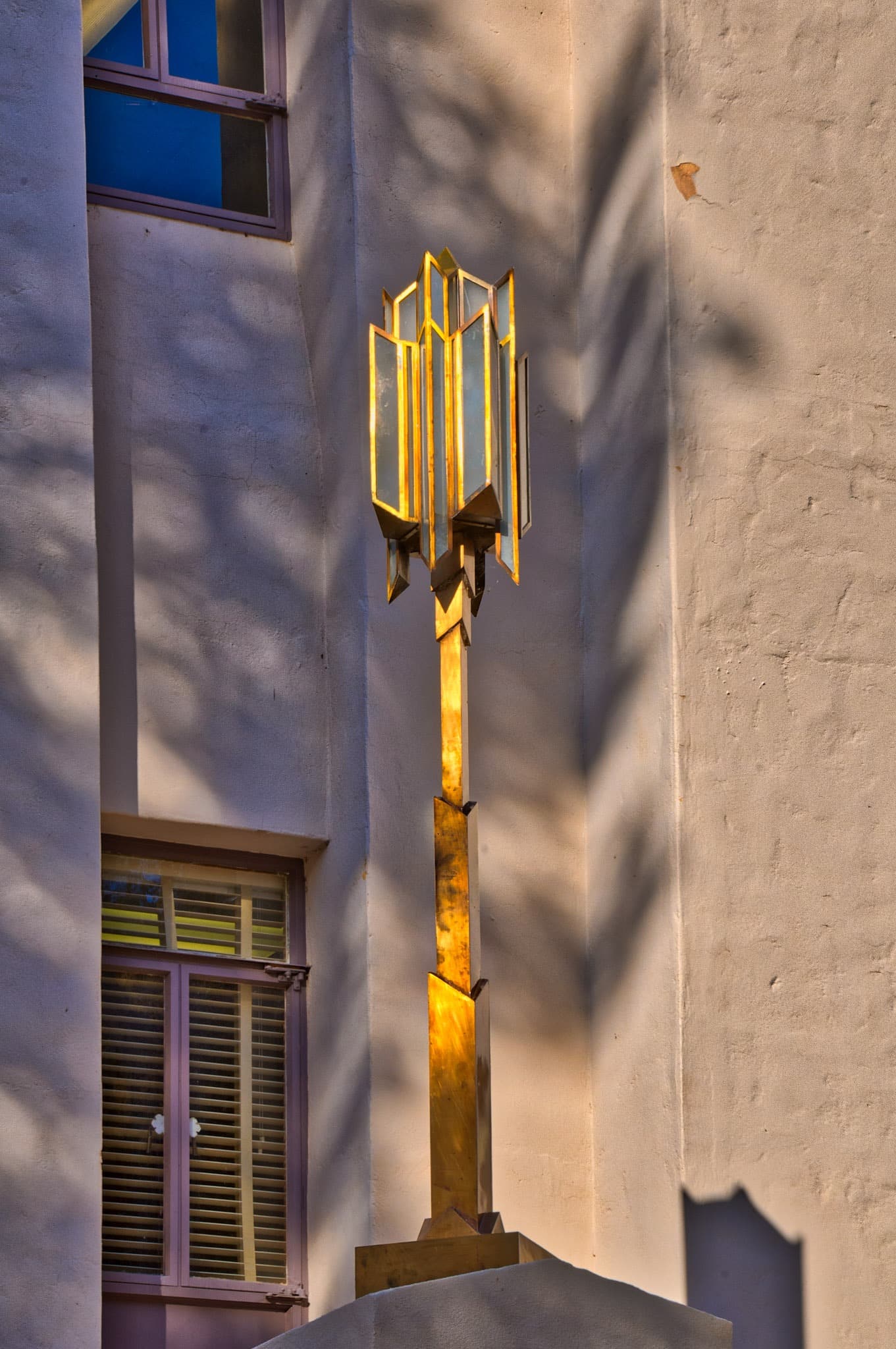 These Art Deco style lamps frame the entrance to the Cochise County Courthous in Bisbee, Arizona. Much of the metal embellishment inside and outside are made of copper. However, these lamps may be casr from a harder copper alloy, such as brass or bronze.