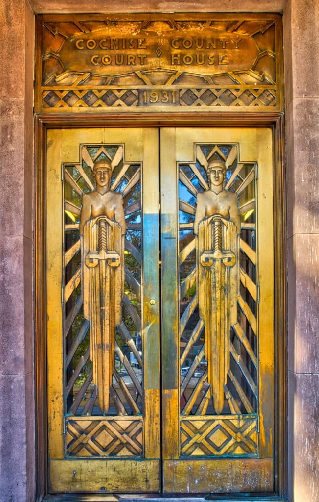 These Art Deco style doors on the front of the Cochise County Courthouse in Bisbee, Arizona, depict a stylized version of Lady Justice holding a sword.