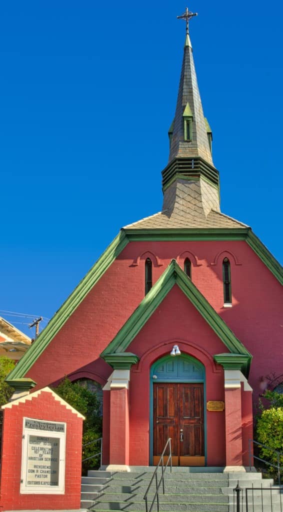 This view of the Covenant Presbyterian Church features the entrance, sign and steeple. It is located on Howell Avenue in Bisbee, Arizona.