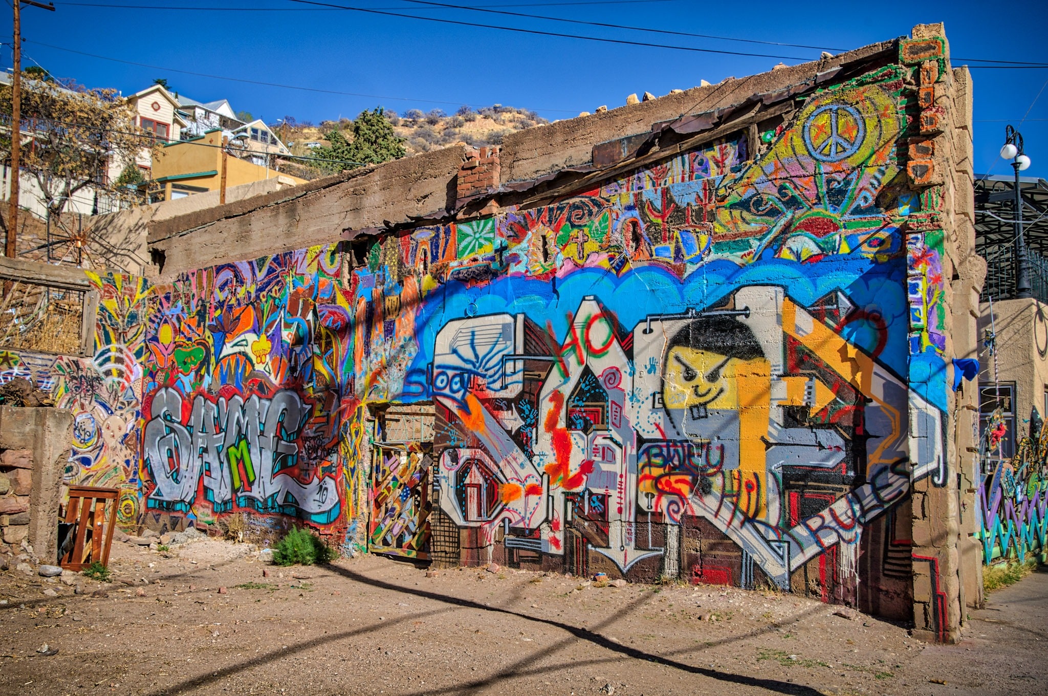 This colorful and intricate graffiti adorn a wall of a ruined building on Brewery Street in Bisbee, Arizona.