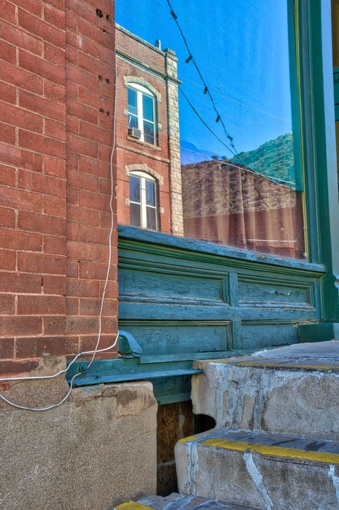 A detail of the reflection in a store window of a building across Brewery Avenue in Bisbee, Arizona.