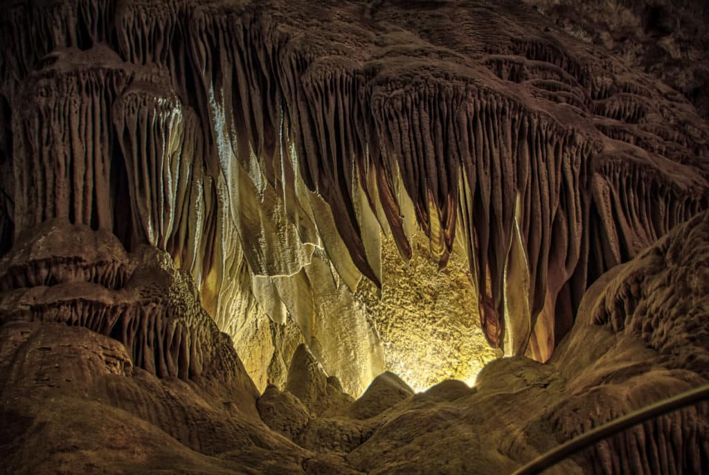 Light shines through draperies in the Big Room at Carlsbad Caverns, highlighting the growth lines of the speleotherms.