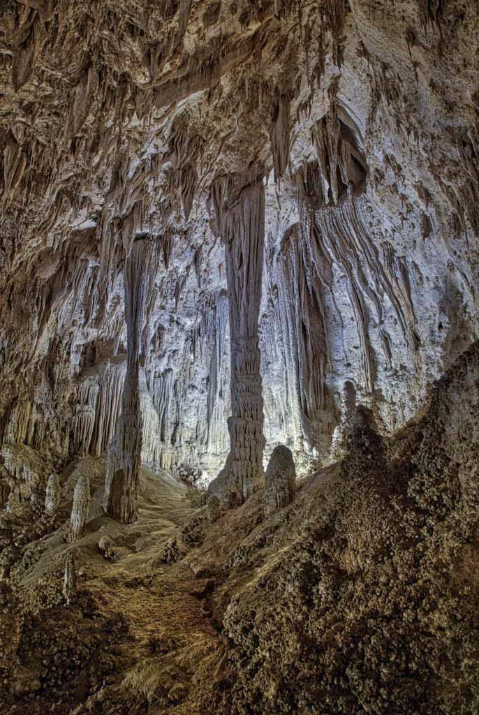 Columns, draperies, popcorn, and other speliotherms in a theatrically-lit alcove in Carlsbad Caverns National Park in New Mexico.