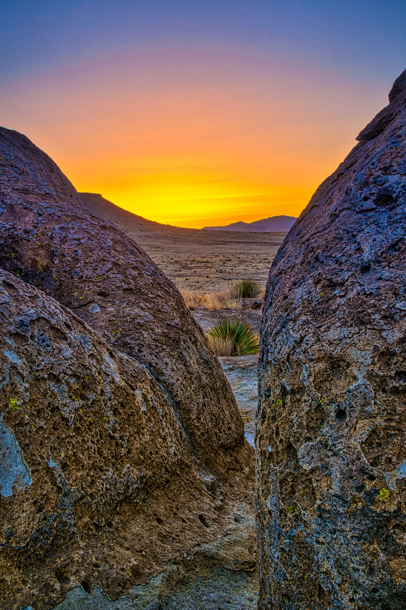 A dramatic sunset view taken through the eroded tuff pinnacles of City of Rocks State Park in New Mexico.
