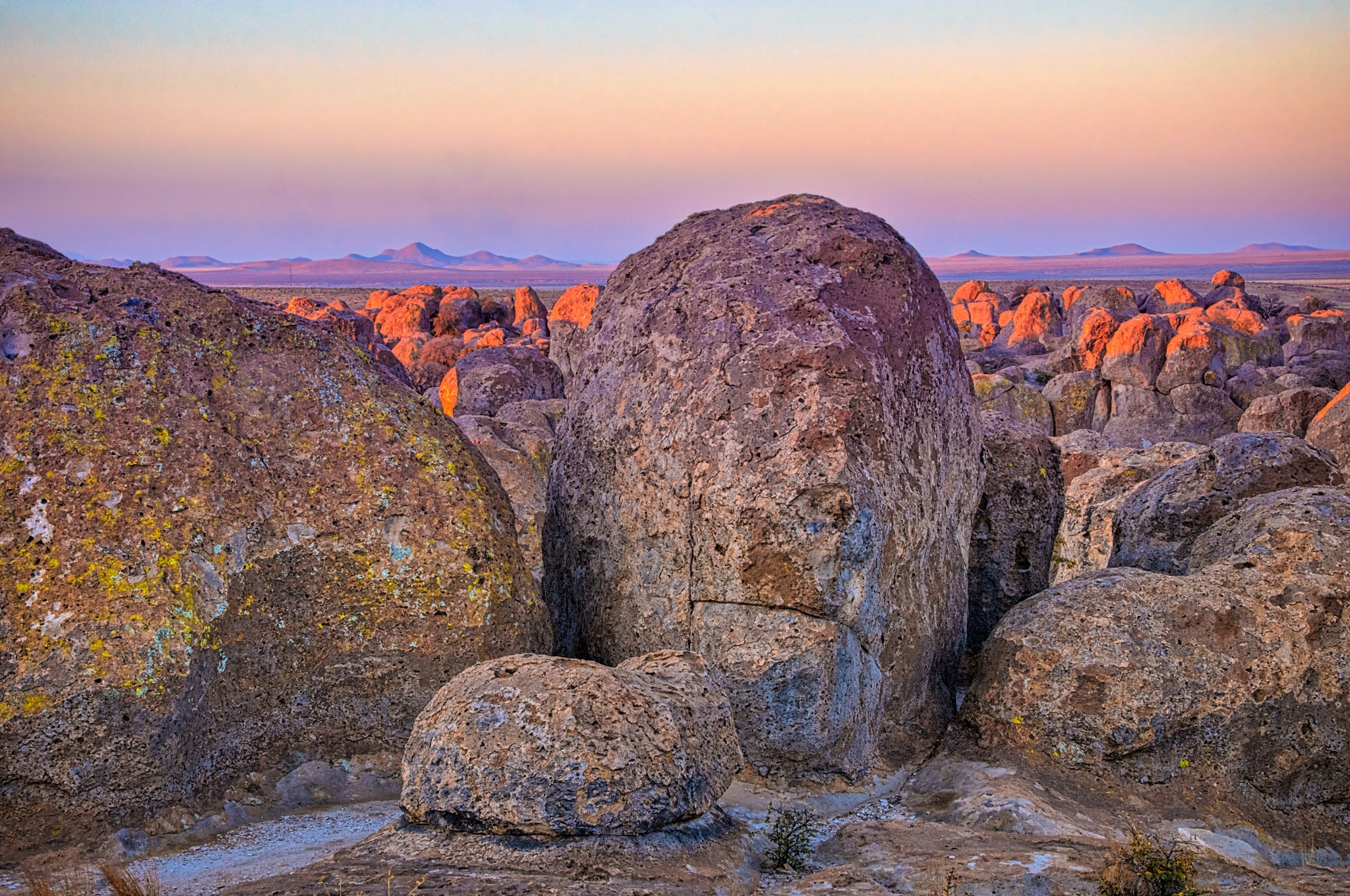 A dramatic sunset view taken through the eroded tuff pinnacles of City of Rocks State Park in New Mexico.