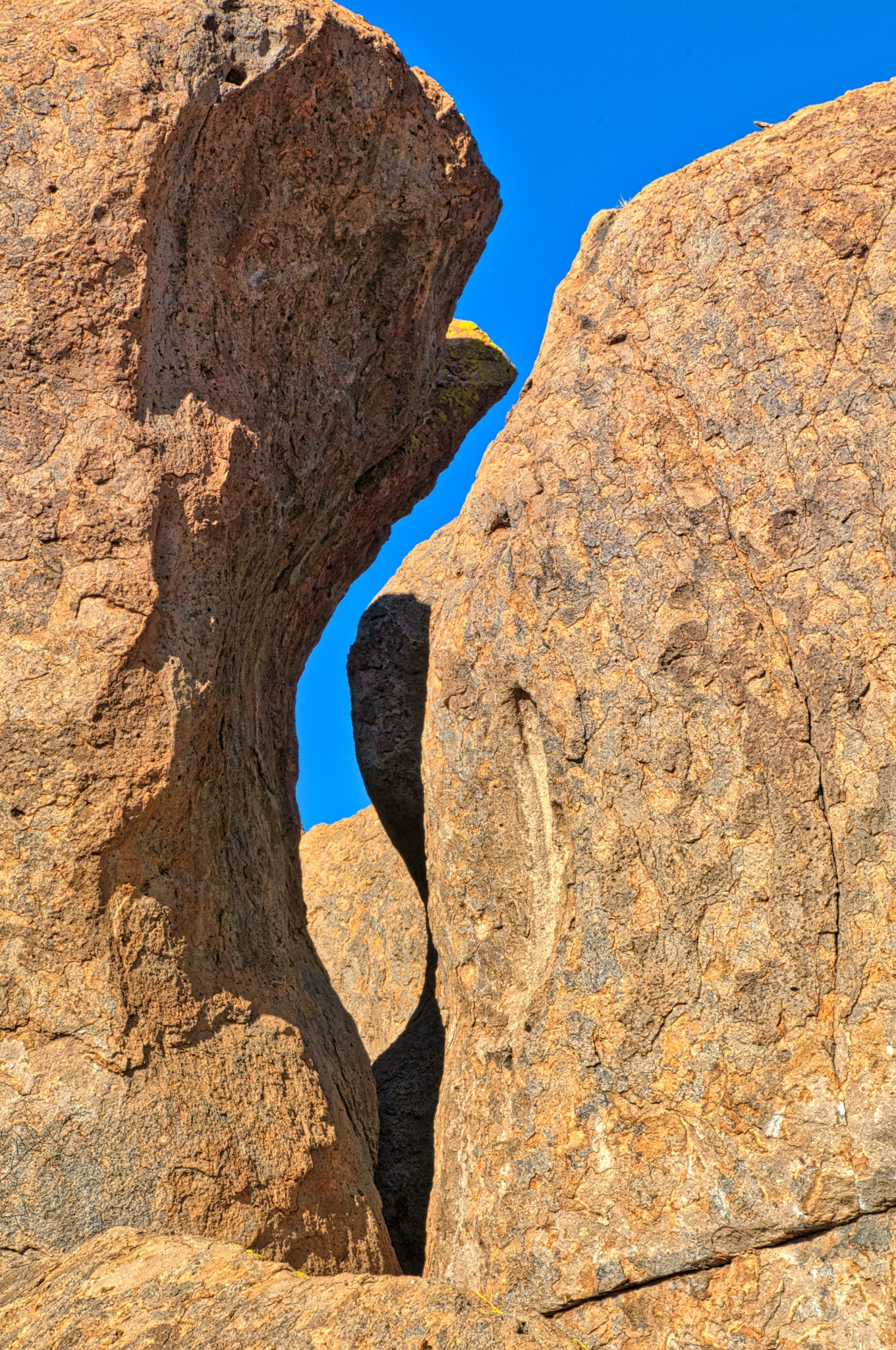 A shadow provides a sinuous component to this slit between two pinnacles giving the whole arrangement a sinuous quality. Taken in City of Rocks State Park between Deming and Silver City, New Mexico.