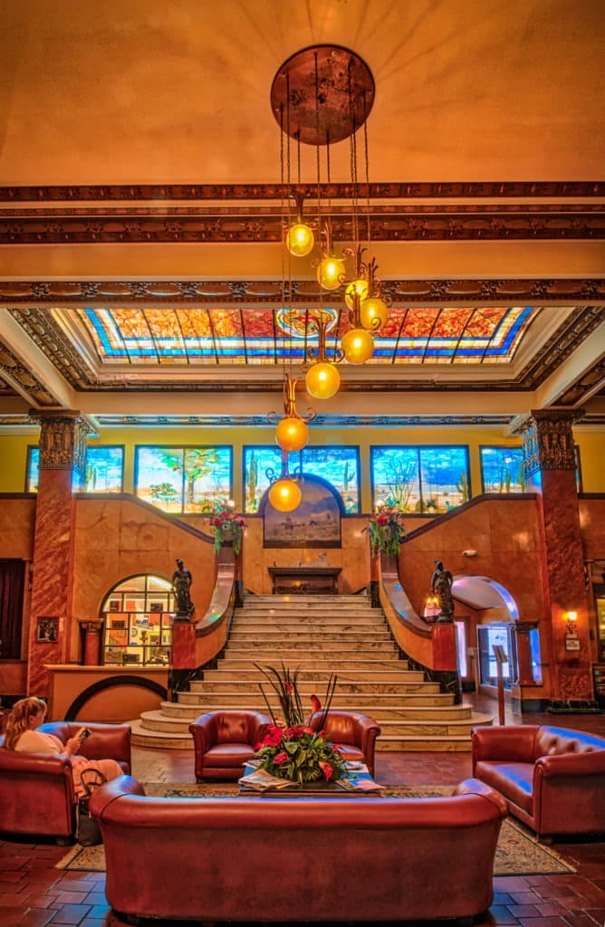 This grand staircase of Italian marble, the Tiffany glass mural, and the stained glass skylight are the centerpieces of the lobby of the Gadsden Hotel in Douglas, Arizona.