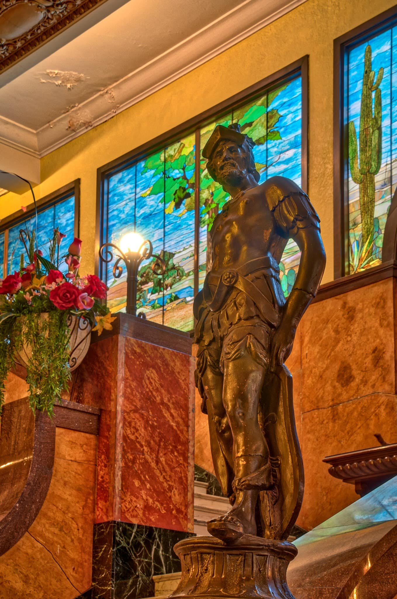 A statue of a conquistador, in honor of the Gadsden Purchase, stands next to the grand staircase in the lobby of the Gadsden Hotel in Douglas, Arizona.