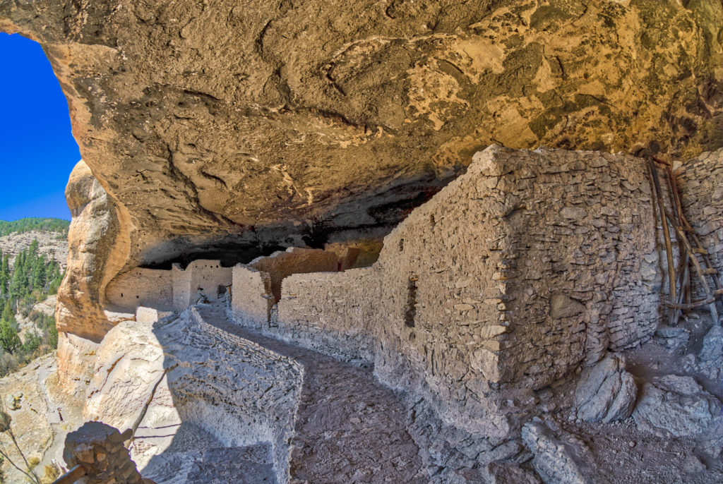 A view along the walkway past multiple Mogollon structures in Gila Cliff Dwellings National Monument near Silver City, New Mexico.