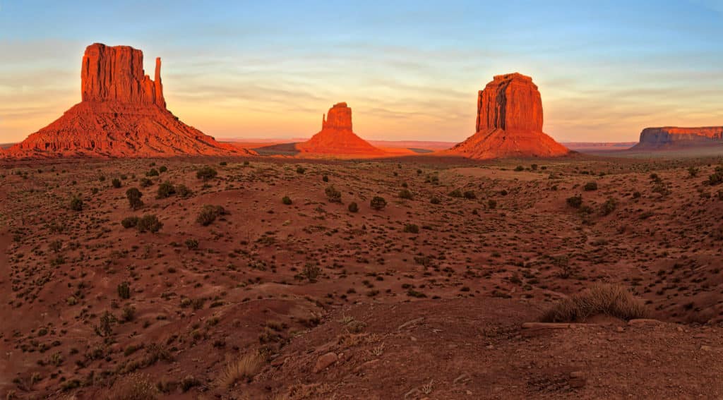 Sunset at Monument Valley Navajo Tribal Park taken from near the visitor's center. West Mitten, East Mitten and Merrick Butte are pictured.