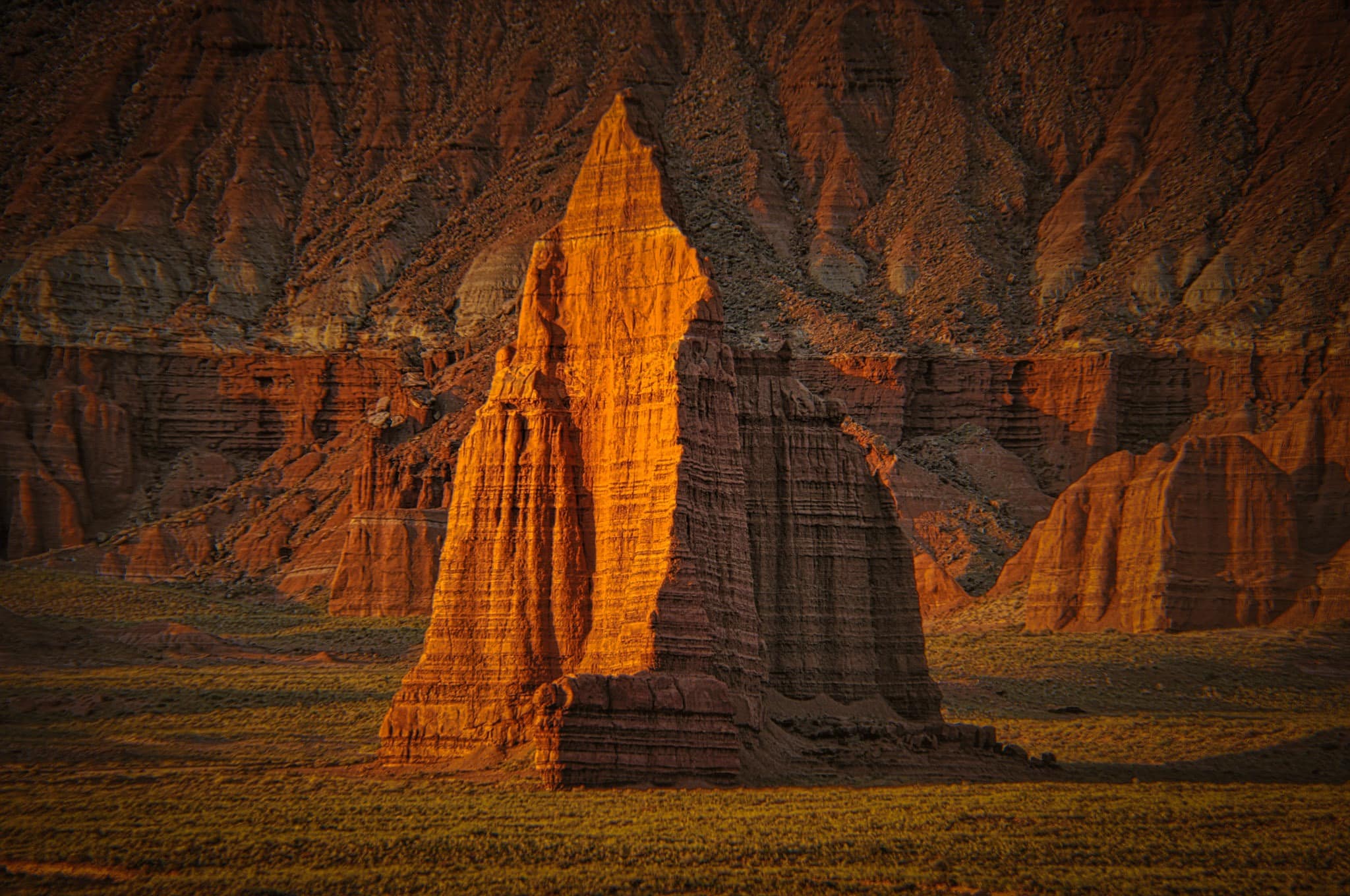 The summer dawn illuminates the face of the Temple of the Sun in Cathedral Valley, Capitol Reef National Park, Utah.