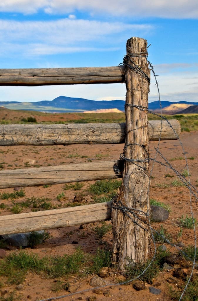 Barbed wire post and rail fence can be seen along Cathedral Road in the Cathedral Valley area of Capitol Reef National Park, Utah.