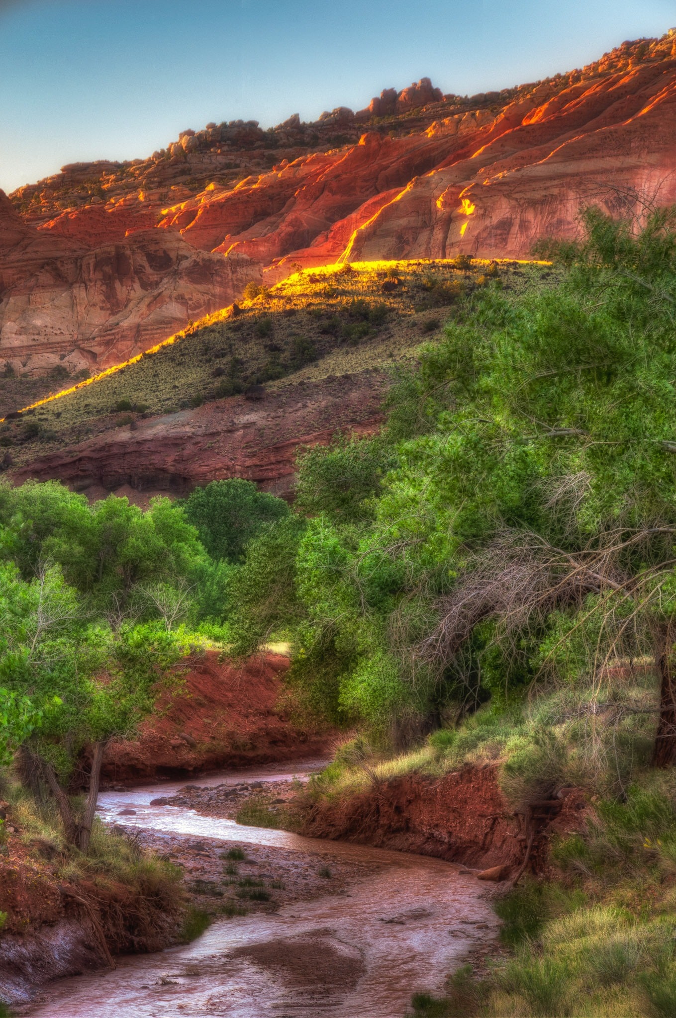 The first light catches the edges of cliffs above Sulphur creek just upstream of its junction with the Fremont River in Capitol Reef National Park.