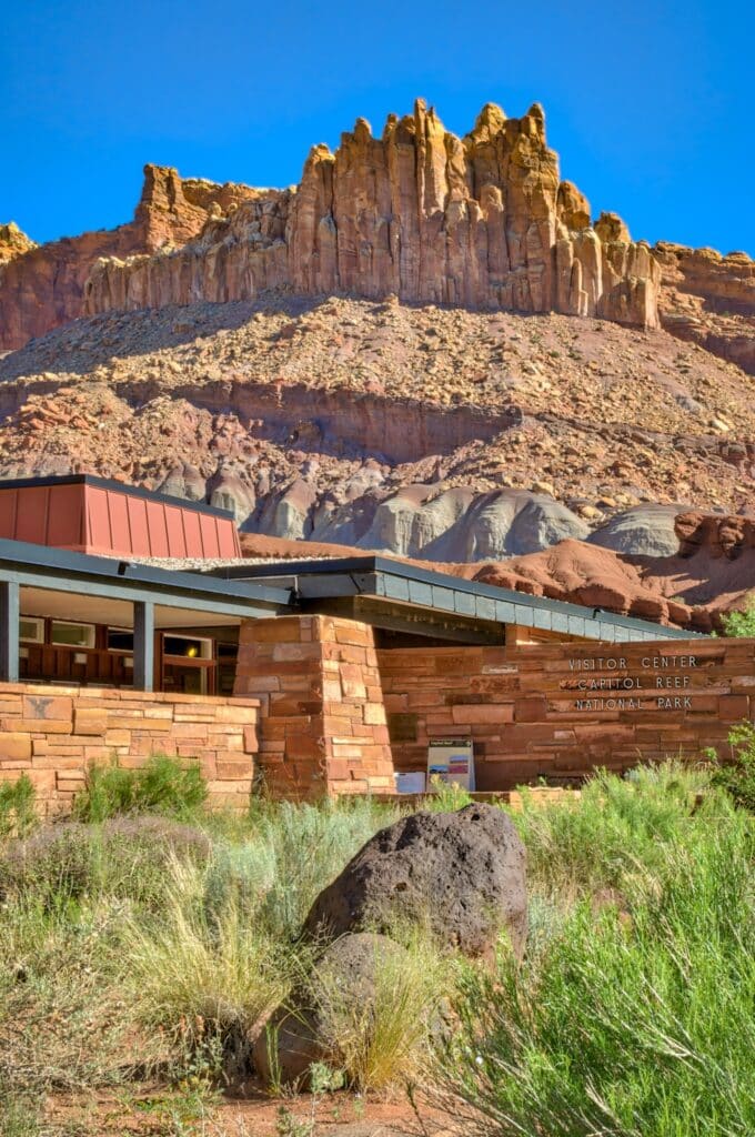 The Capitol Reef National Park Visitor Center is located off Utah State Route 24, just below The Castle, a sandstone rock formation.
