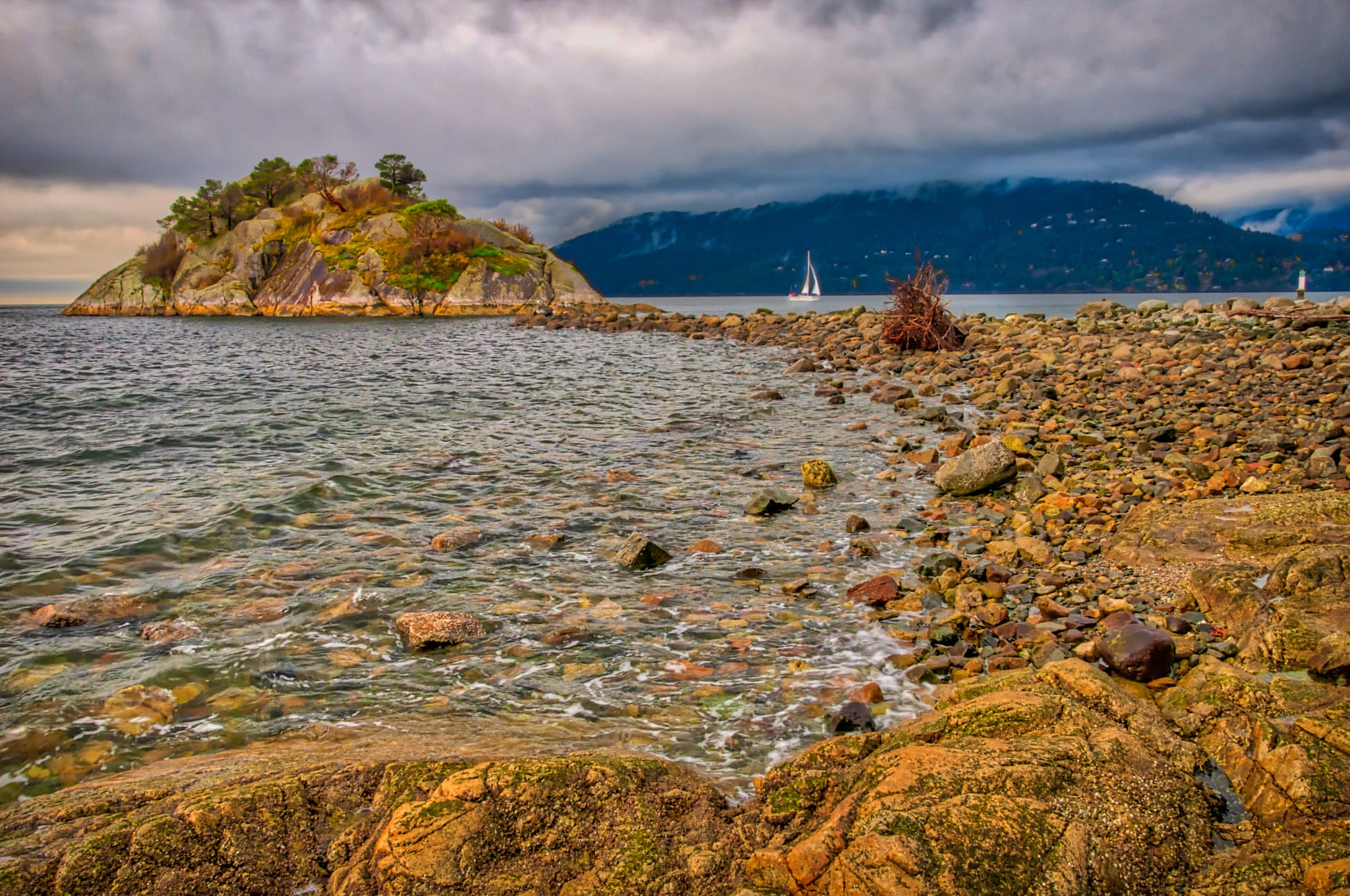 A view at sunset along the shore of Whytecliff Park with Bowyer Island, in West Vancouver, British Columbia.