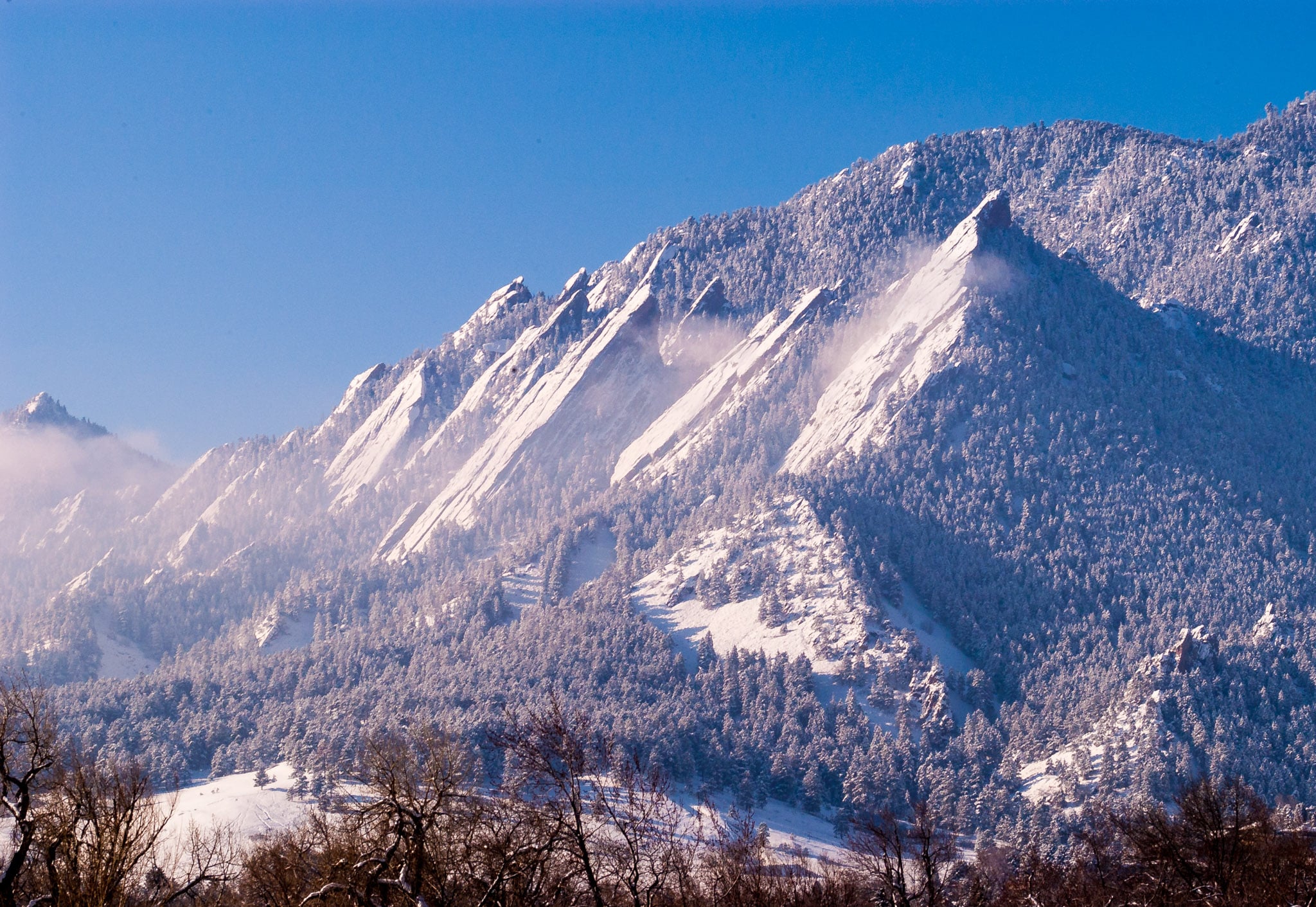 Snow dusts the Flatirons on a cold morning in Boulder, Colorado.