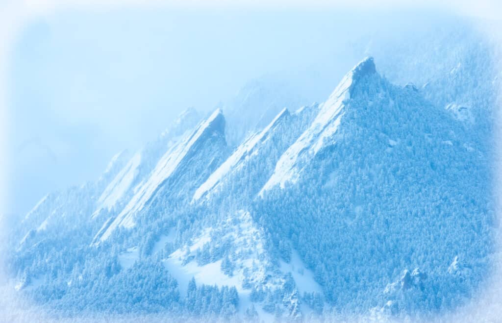 This is a view of the Flatirons on the west side of Boulder, Colorado, during a light snowstorm.