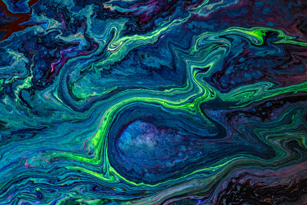 Abstract patterns made by mixing acrylic paints and fluorescent paint with oil and silicone, then photographing the results.