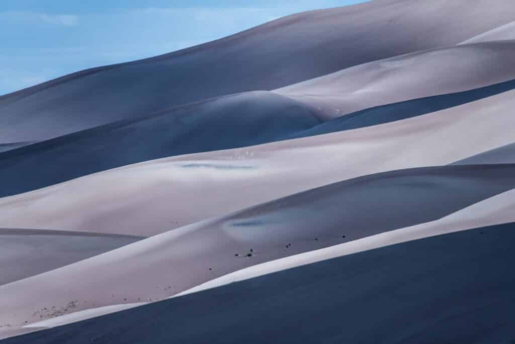 Partly cloudy skies cause interesting patterns of light and shadow on the sand dunes at Great Sand Dunes National Park and Preserve near Alamosa, Colorado.