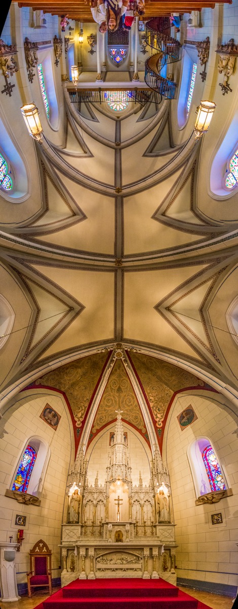 This panorama shows the complete ribbed vault of the Loretto Chapel from the high altar in the apse to the main entrance in the front. The chapel is located in Santa Fe, New Mexico.