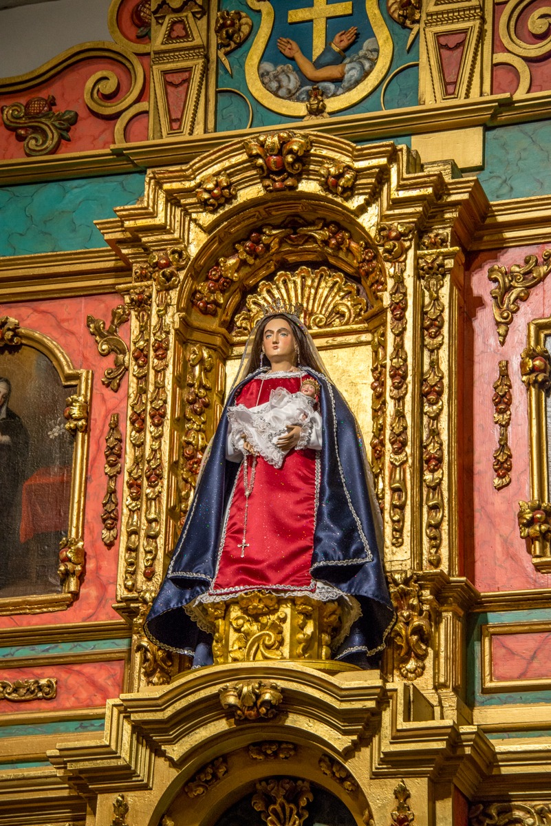 This close-up of La Conquistadora in the La Conquistadora Chapel, shows Her adorned in one of Her many vestments and rosaries. This staue of Our Lady of the Rosary, renamed La Conquistadora, dates from 1626 and the first church built on this site. This makes her the oldest Madonna in the United States.