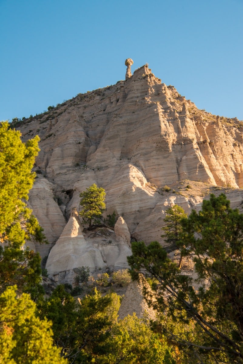A lone hoodoo perches above the volcanic cliffs of Kasha-Katuwe Tent Rocks National Monument in northern New Mexico.