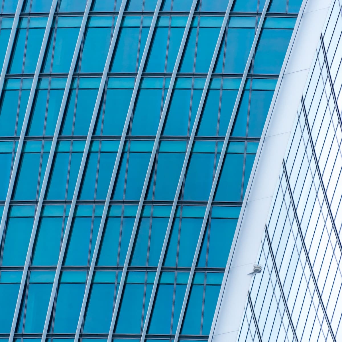 Detail of the skyscraper at 20 Fenchurch Street. It is a glass, aluminum, and steel structure, nicknamed the Walkie-Talkie Building due to its shape. The top-heavy design is partly intended to maximise floor space towards the top of the building, where rent is typically higher. This image is part of our London architectural abstracts portfolio.