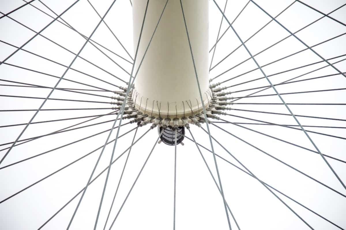 Here is a view of the London Eye as seen from the base. This observation wheel sits on a double pier on the south bank of the Thames River in London, England. It looks like a giant bicycle wheel. This image is part of our London architectural abstracts portfolio.