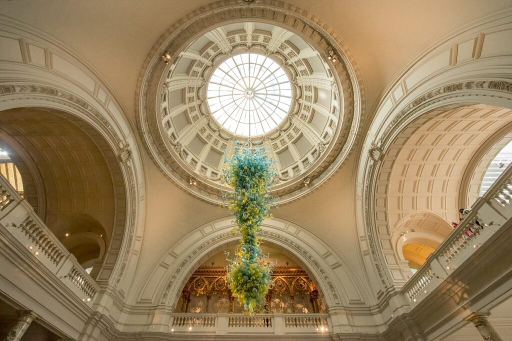 This is a view under the dome of the Victoria and Albert Museum. A chandelier by Dale Chihuly hangs from the rotunda.