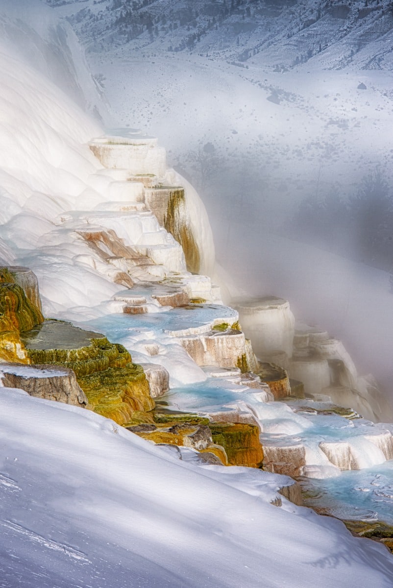 Even though the terraces of Mammoth Hot Springs, in Yellowstone National Park, are covered with ice, there is still enough super-heated water to cause billows of steam. The temperature is -24 F.