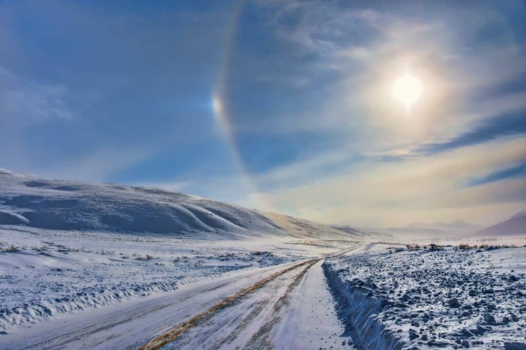 A ring appears around a milky sun as we travel along the Northeast Entrance Road in Yellowstone National Park in Wyoming. A sun dog is caused by refraction of sunlight by ice crystals in the atmosphere.