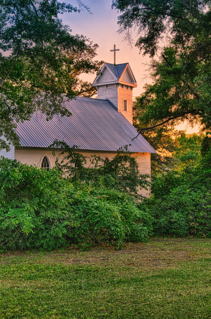 The sun sets on this 1881 clapboard church in Evergreen, Alabama