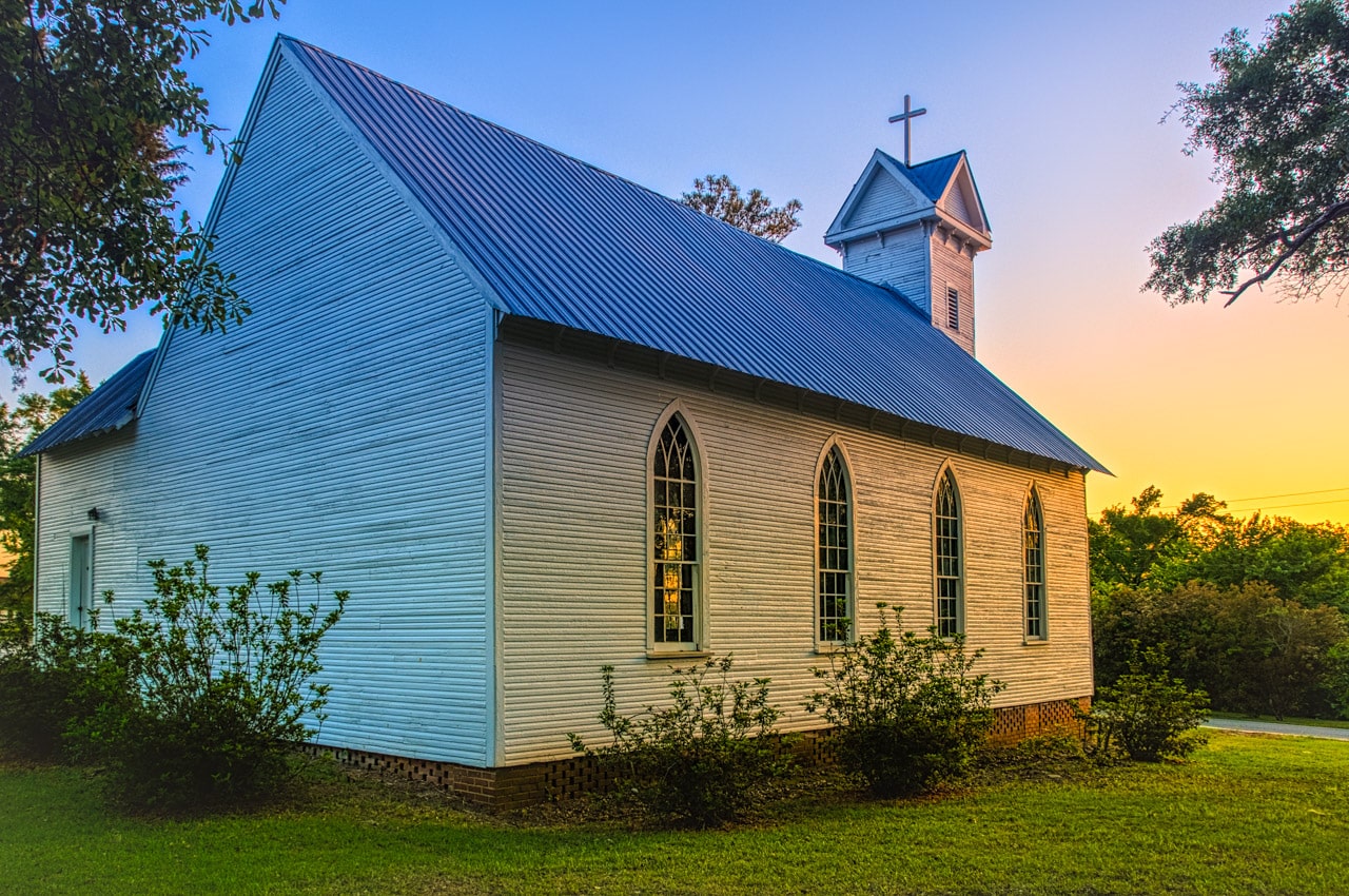 The sun sets on this 1881 clapboard church, the former St. Mary's Episcopal Church, in Evergreen, Alabama.