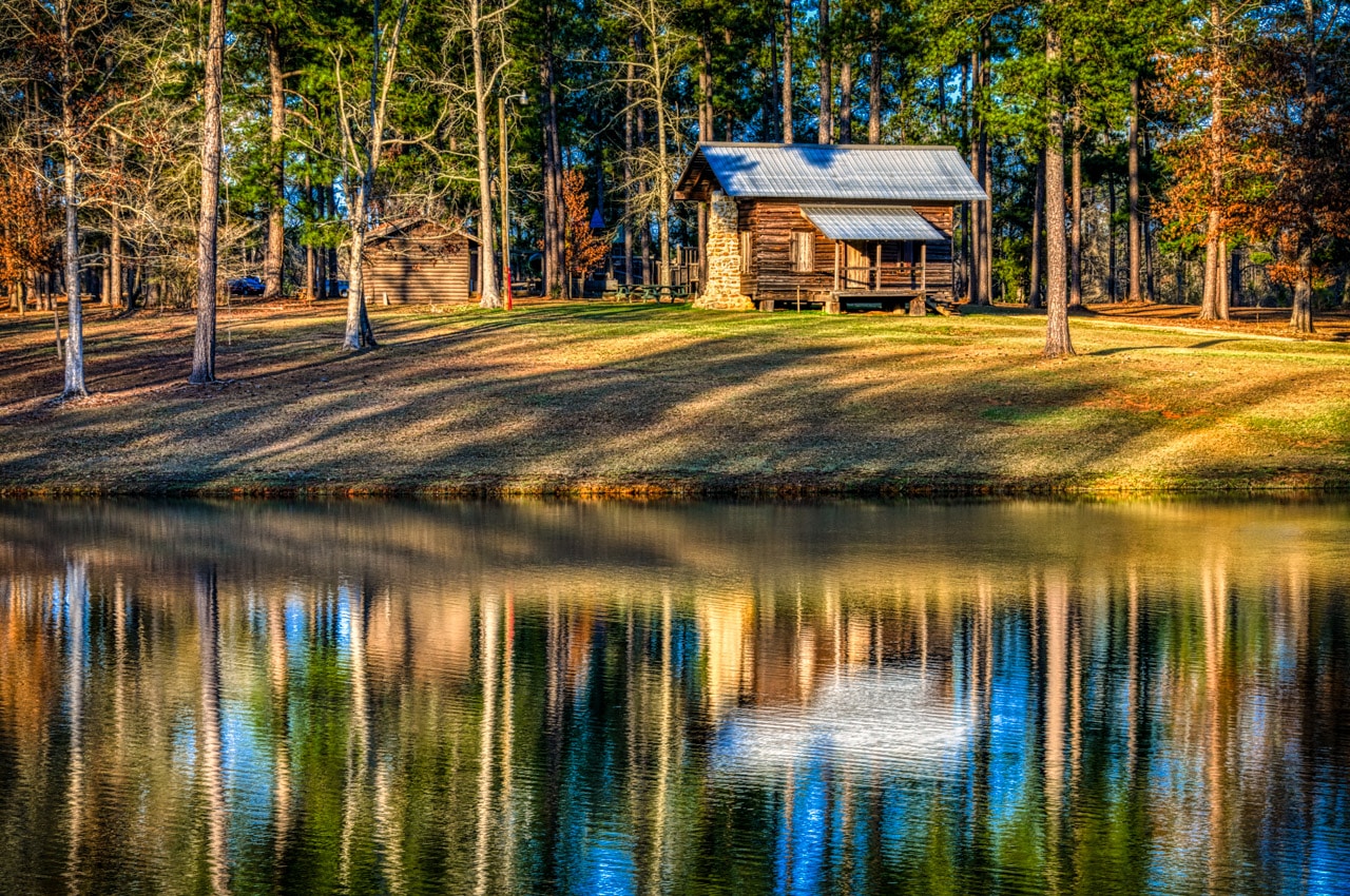 This restored cabin sits near the lake in Evergreen Municipal Park in Evergreen, Alabama. It is a section of a larger cabin built ca. 1877 by John Daniel Weaver, Jr. This section of the cabin originally served as the dining room.