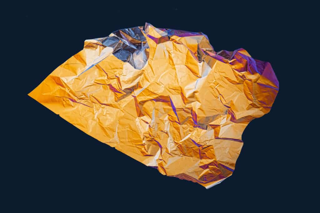 A crumpled sheet of plastic packaging is photographed using polarizing filters.