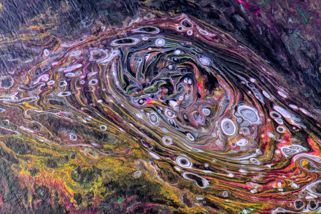 This is a photograph of different colored paint swirling in abstract compositions.