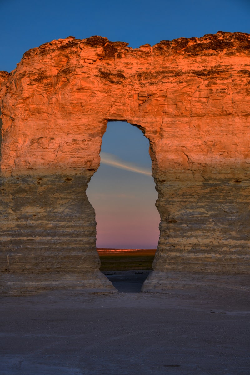 Cliffs of Niobrara Chalk glow orange as viewed through a window in one of the Monument Rocks formations near Oakley, KS.
