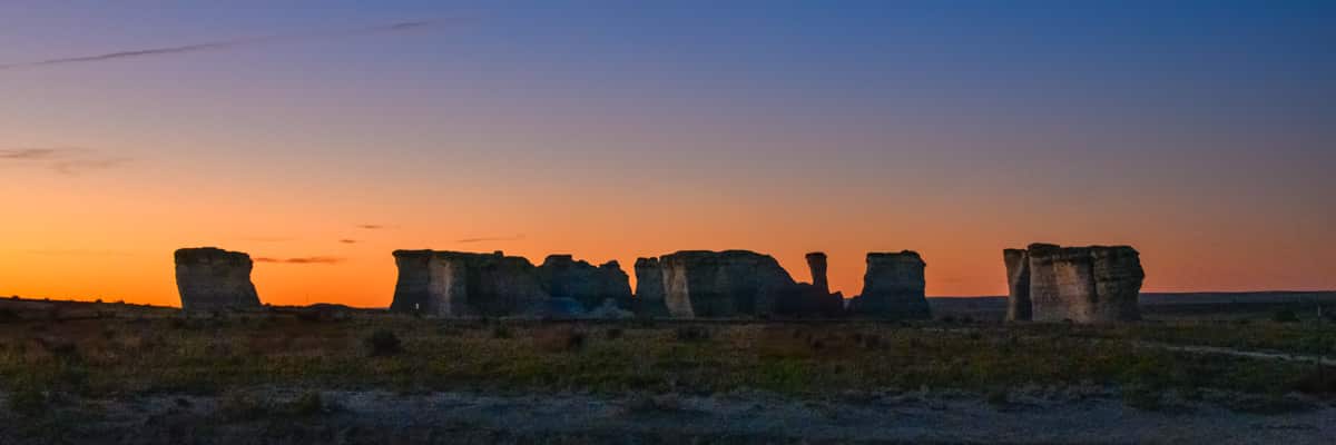 A panorama of a grouping of formations at Monument Rock at dawn near Oakley, KS.