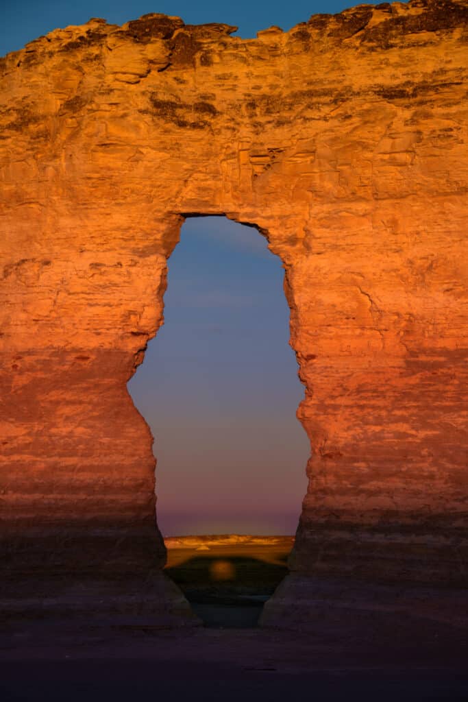 At sunrise, a shadow of a window appears through a window in one of the Monument Rocks formations near Oakley, KS.