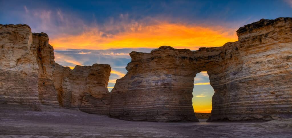 Sunrise colors shine through a window in one of the formations at Monument Rocks near Oakley, KS.