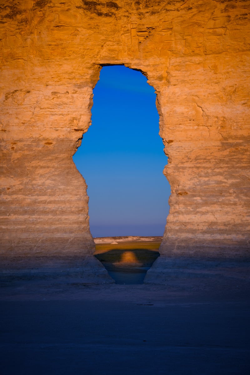 At sunrise, a shadow of a window appears through a window in one of the Monument Rocks formations near Oakley, KS.