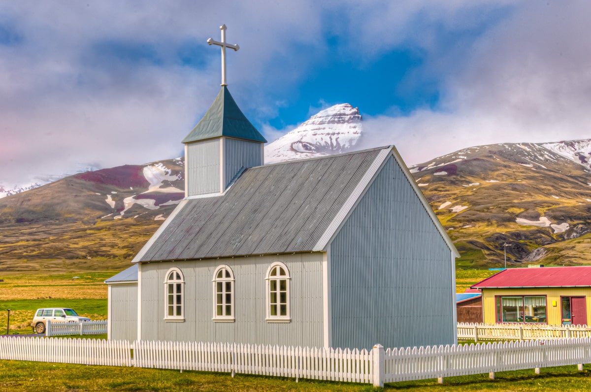 Peak of the mountain Dyrfjoll and the church Bakkagerðiskirkja in eastern Iceland.