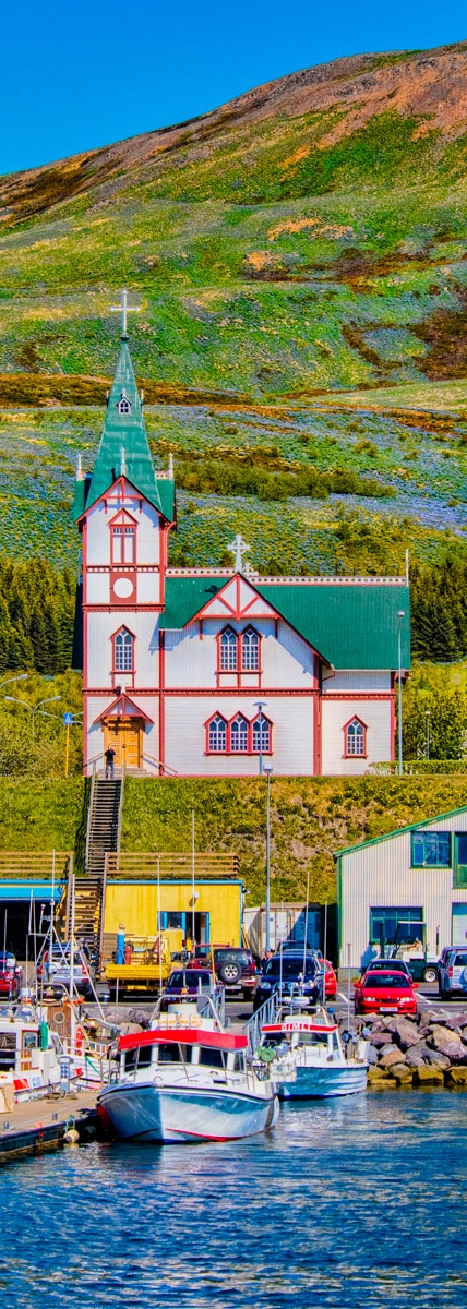 The church in the port town of Húsavík is a major landmark, with the belltower measuring 26 meters (over 85 feet) in height. It was built in 1907 from wood, a somewhat costly building material because it had to be imported from Norway.