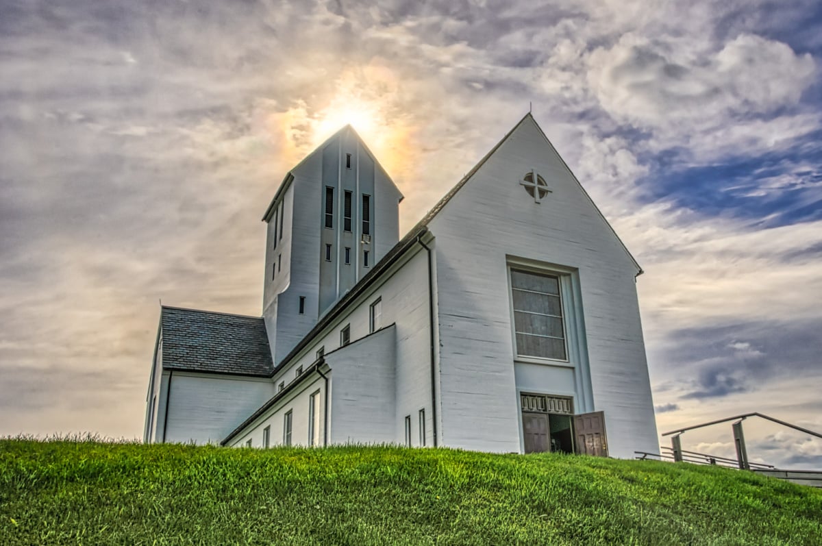 The community of Skálholt has been a center of religion in Iceland since 1056 AD. Today, it hosts a complex of libraries, offices, museums, historical ruins, graves, schools, and this church. Skálholt is located in southwestern Iceland.