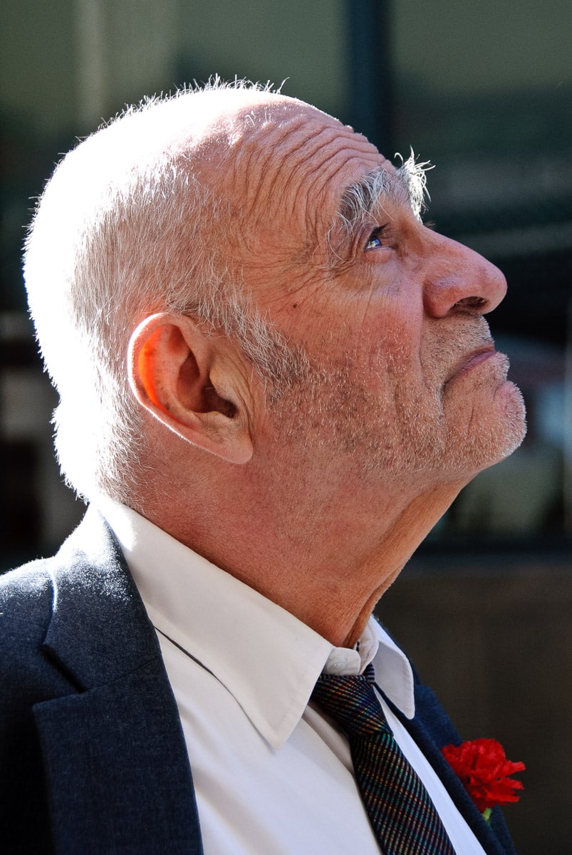 An old gentleman with a boutonniere looks up as he heads for coffee near Grand Central Station, New York City.