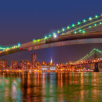 This nighttime panorama of the Brooklyn Bridge also features the Manhattan skyline and the Manhattan Bridge.