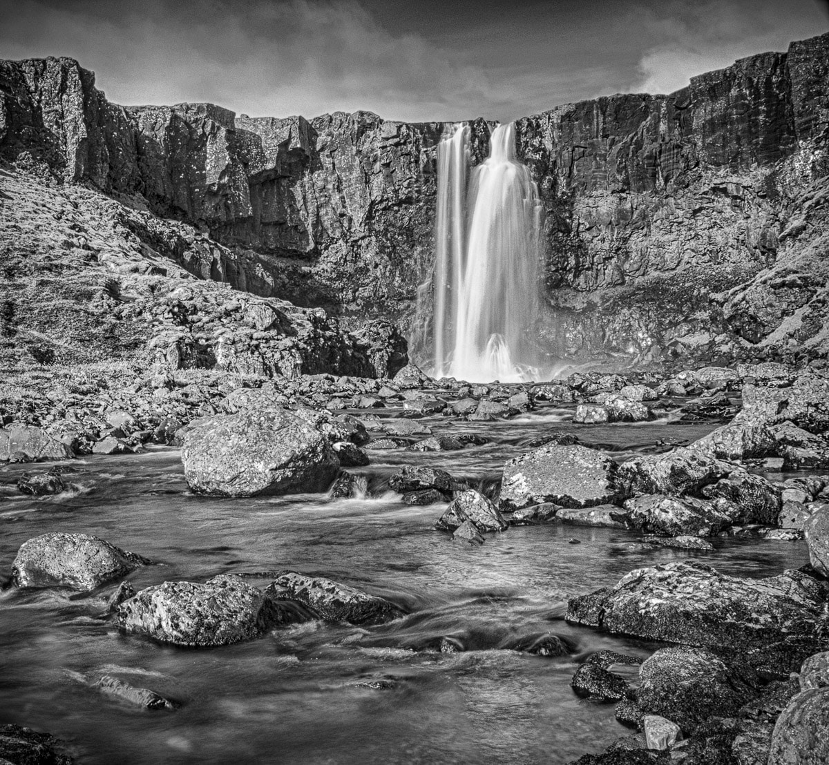 A wide shot (in black and white) of the waterfall Gufufoss near Seyðisfjördur in eastern Iceland.