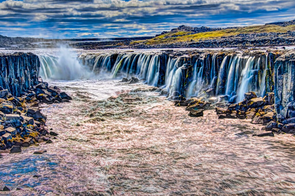 The waterfall Selfoss, just south of Jökulárgljúfur National Park in northern Iceland, forms a horseshoe-shaped waterfall as it cascades over a lava layer in the Jökulsá á Fjöllum river.